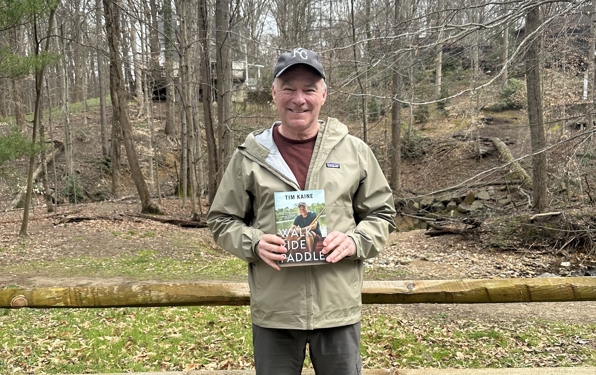 Tim Kaine holding a copy of Walk Ride, Paddle
