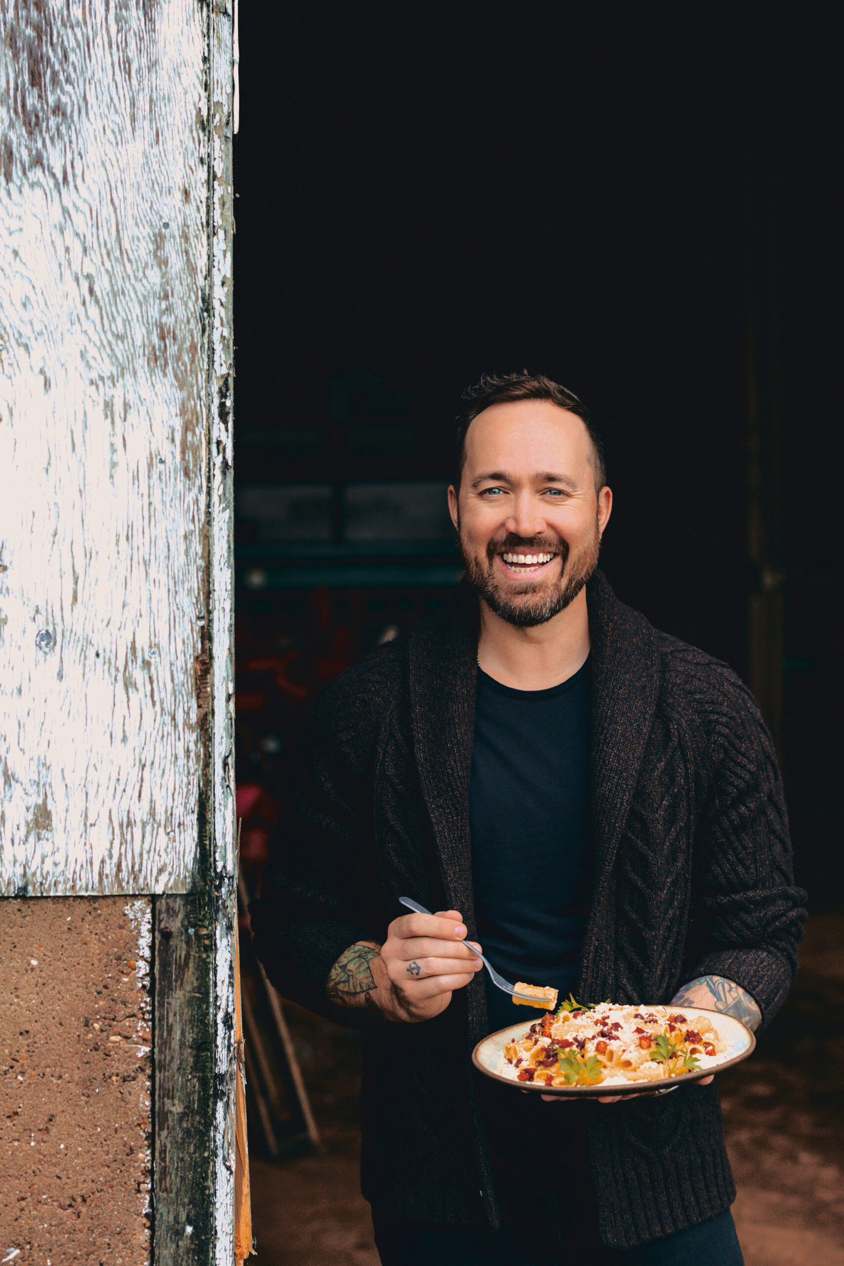 Dennis in barn with food